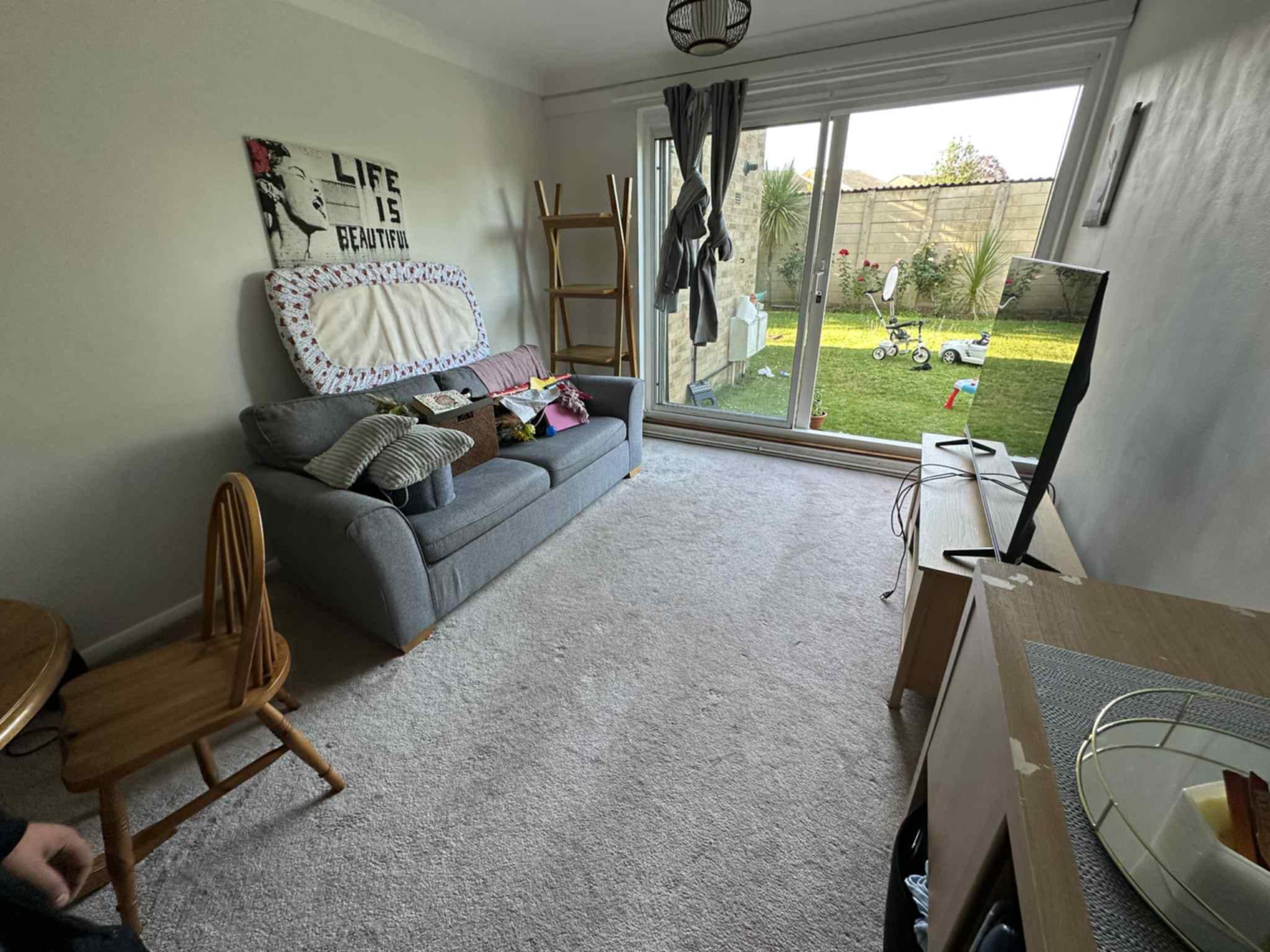 Living room with grey sofa and clean carpet